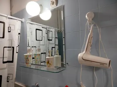 a bathroom with a mirror and a blow dryer at Moulin ROSE in Belgrade