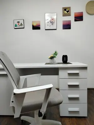 a white desk with a chair and pictures on the wall at Moulin ROSE in Belgrade