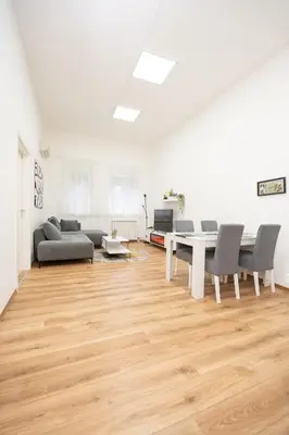 a living room with a couch and a table and chairs at Apartment Moonstone 4 in Belgrade