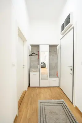 a hallway with white doors and a mirror at Apartment Moonstone 4 in Belgrade