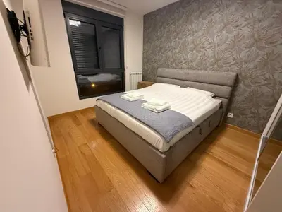 a bedroom with a bed with towels on it at Belgrade Forest Gate near center in Belgrade