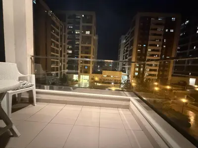 a balcony with a view of a city at night at Belgrade Forest Gate near center in Belgrade