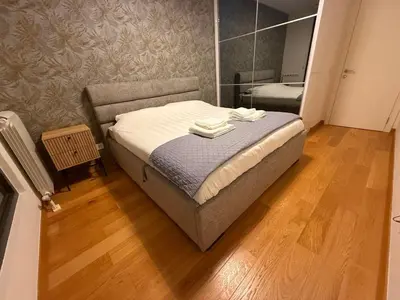 a bedroom with a bed with two towels on it at Belgrade Forest Gate near center in Belgrade