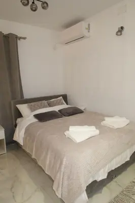 a bedroom with a bed with two towels on it at Infinity in Belgrade