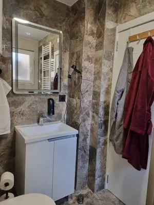 a bathroom with a sink and a mirror and a toilet at Infinity in Belgrade