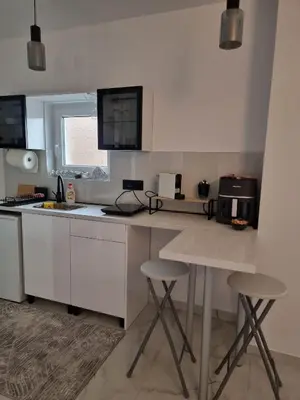 a kitchen with a counter and two stools in it at Infinity in Belgrade