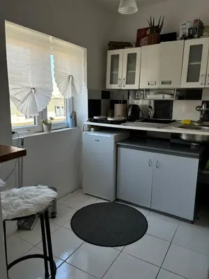 a kitchen with white cabinets and a counter top at Kneginje Ljubice apartment in Belgrade