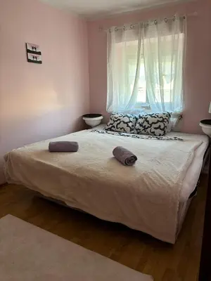 a bedroom with a bed with two pillows and a window at Kneginje Ljubice apartment in Belgrade