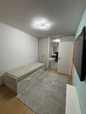 a bedroom with a bed and a tv in it at Vist Sava Center Residence in Belgrade