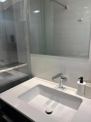 a bathroom with a white sink and a mirror at Vist Sava Center Residence in Belgrade