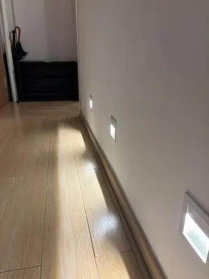 a room with white walls and a wooden floor at Vist Sava Center Residence in Belgrade