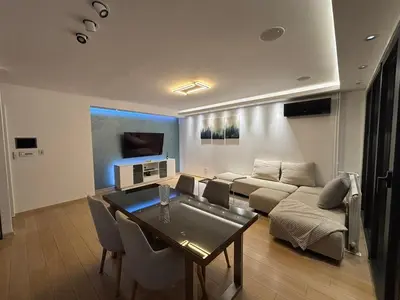 a living room with a couch and a table at Vist Sava Center Residence in Belgrade