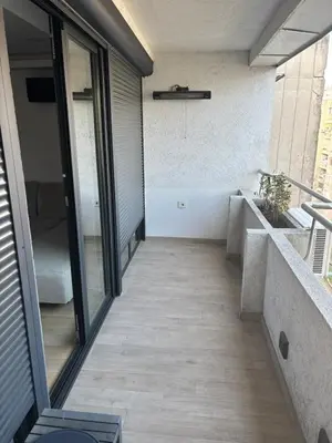 a hallway of a house with glass doors and a balcony at Vist Sava Center Residence in Belgrade