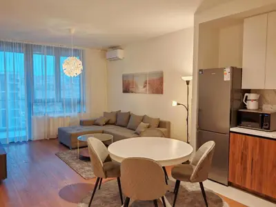 a living room with a couch and a table and chairs at SnowWhite Belgrade Waterfront in Belgrade