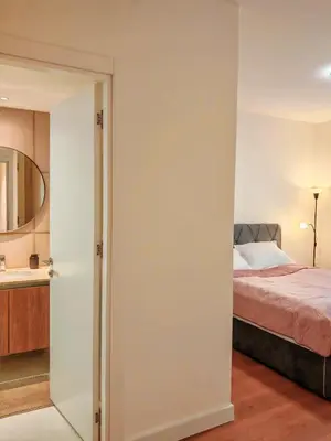 a bedroom with a bed and a mirror at SnowWhite Belgrade Waterfront in Belgrade