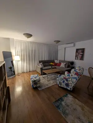a living room with a couch and a table at Nova Vracar - Luxury Apartment & Private Parking in Belgrade