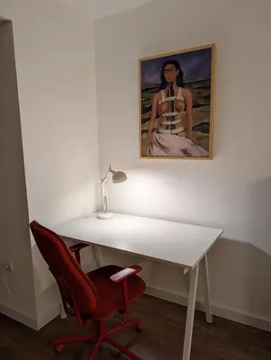 a white desk with a red chair and a painting at Nova Vracar - Luxury Apartment & Private Parking in Belgrade