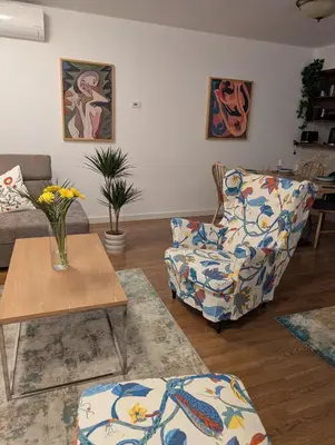 a living room with a couch and a chair and a table at Nova Vracar - Luxury Apartment & Private Parking in Belgrade