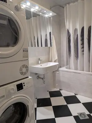 a bathroom with a washing machine and a sink at Nova Vracar - Luxury Apartment & Private Parking in Belgrade