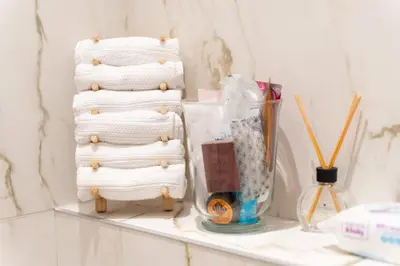 a shelf with three stacks of towels on it at Luxury Apartment Old Town City Center in Belgrade