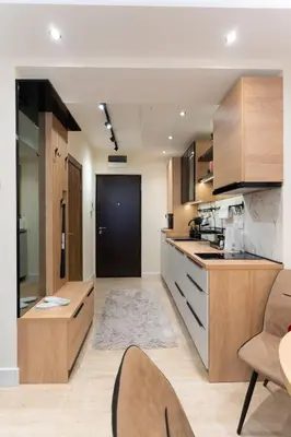 a kitchen with wooden cabinets and a table and chairs at Luxury Apartment Old Town City Center in Belgrade