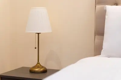 a lamp sitting on a table next to a bed at Luxury Apartment Old Town City Center in Belgrade