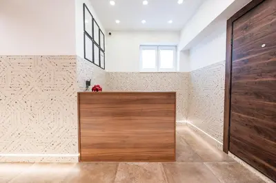 a large wooden door in a room with a wall at Stella Di Notte City Center Studios in Belgrade
