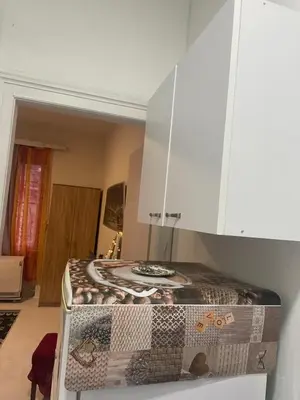 a kitchen with a counter in a room at Ena's apartman in Belgrade