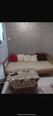a bed with a blanket on it in a room at Ena's apartman in Belgrade