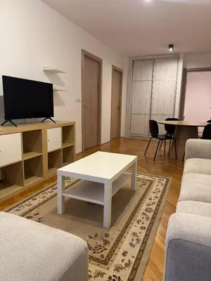 a living room with a white coffee table and a tv at Jana's in Belgrade