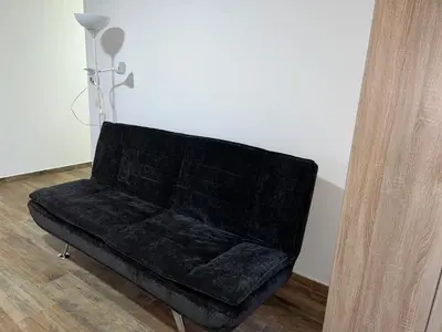 a black couch sitting in the corner of a room at Mimura 3 in Belgrade