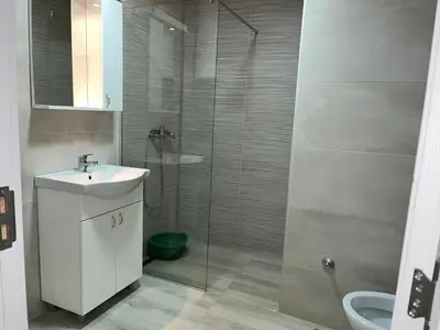 a bathroom with a shower with a sink and a toilet at Mimura 3 in Belgrade