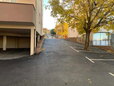 an empty parking lot next to a building with a tree at Mimura 3 in Belgrade