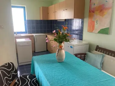 a kitchen with a table with a vase with flowers on it at Artists Apartment in Beograd