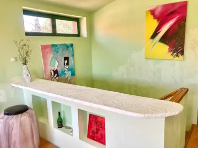 a counter in a room with paintings on the wall at Artists Apartment in Beograd