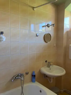a bathroom with a sink and a bath tub at Artists Apartment in Beograd