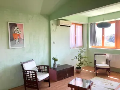 a living room with chairs and a table at Artists Apartment in Beograd
