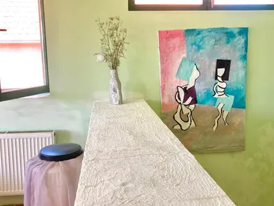 a room with a table with a vase and a painting at Artists Apartment in Beograd