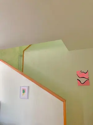 a white refrigerator with a picture of lips on the wall at Artists Apartment in Beograd