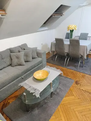 a living room with a couch and a table at Apartman 32 in Inđija