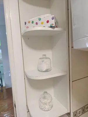 a white cabinet with two glass dishes and a box at Apartman 32 in Inđija