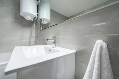 a bathroom with a white sink and a towel at Apartment Marshall Resavska in Belgrade