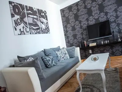 a living room with a couch and a tv at Apartment Marshall Resavska in Belgrade