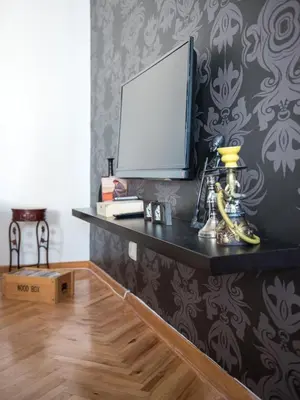 a black shelf with a tv on a wall at Apartment Marshall Resavska in Belgrade