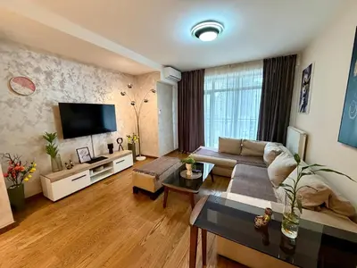 a living room with a couch and a flat screen tv at The Gates Apartments Belgrade Waterfront in Belgrade