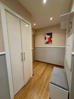 an empty room with a white door and wooden floors at The Gates Apartments Belgrade Waterfront in Belgrade