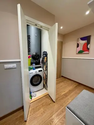 a laundry room with a washer and dryer at The Gates Apartments Belgrade Waterfront in Belgrade