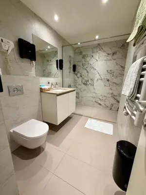 a bathroom with a toilet and a sink and a shower at The Gates Apartments Belgrade Waterfront in Belgrade