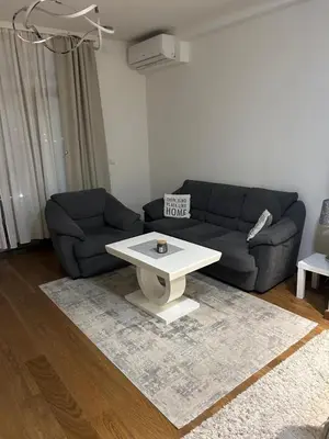 a living room with a couch and a coffee table at The Gates Apartments Belgrade Waterfront in Belgrade