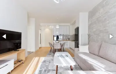 a living room with a couch and a table at The Gates Apartments Belgrade Waterfront in Belgrade